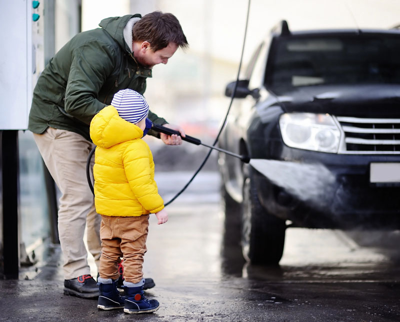 Boy-learning-to-wash-car-with-dad