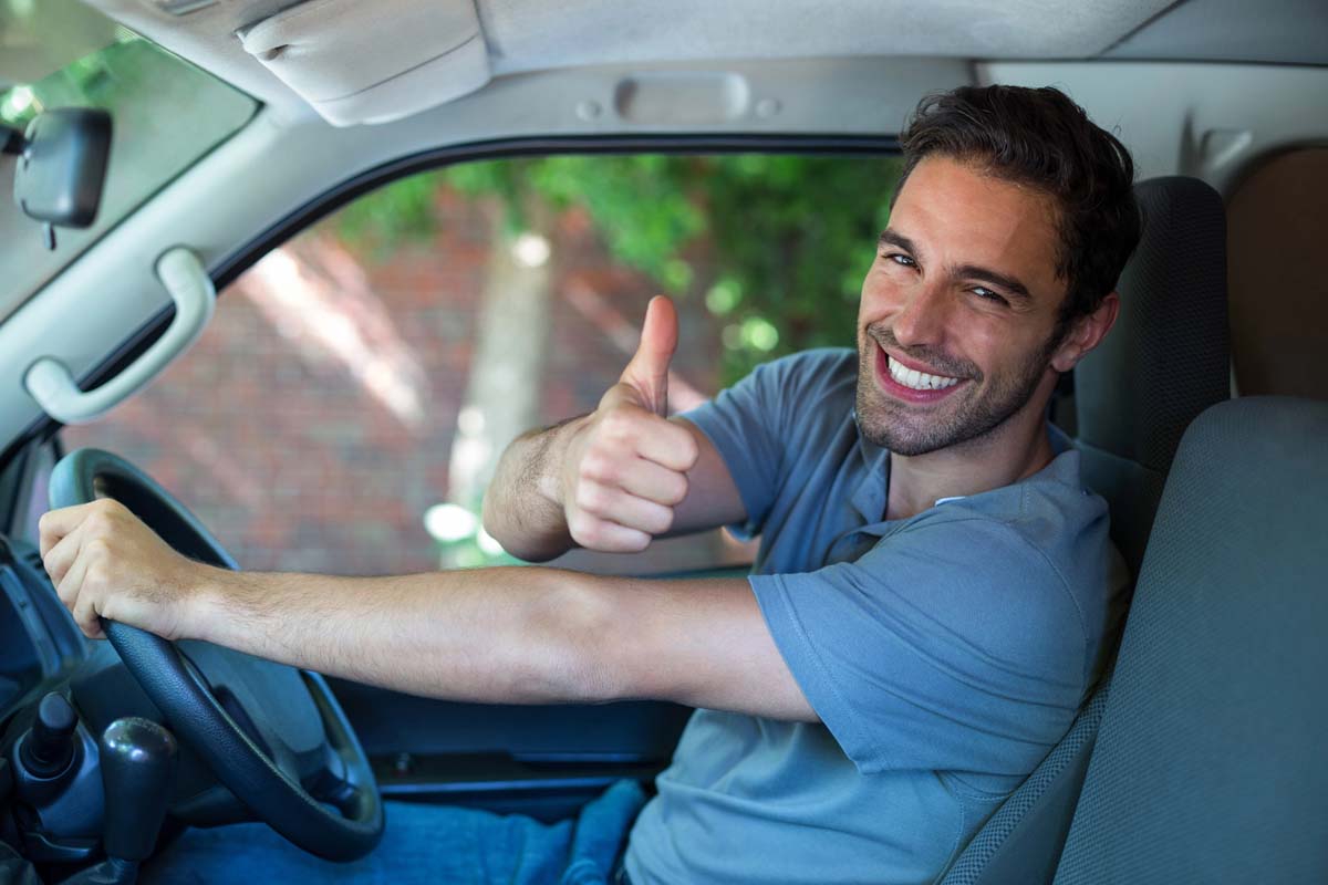 Man happy driving clean car